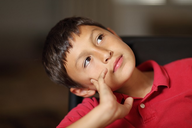 Boy thinking or day dreaming
