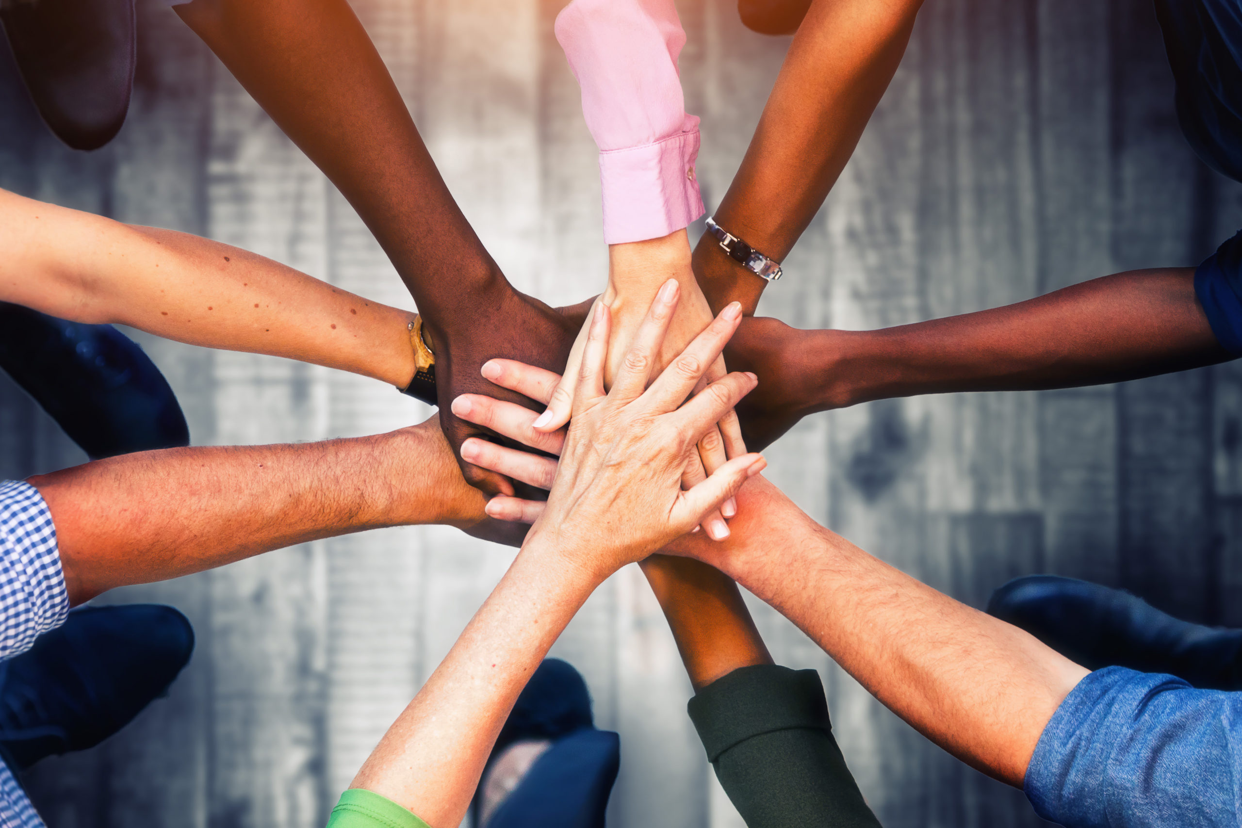 Image of people putting their hands together.