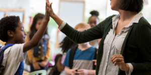 Image of teacher with students